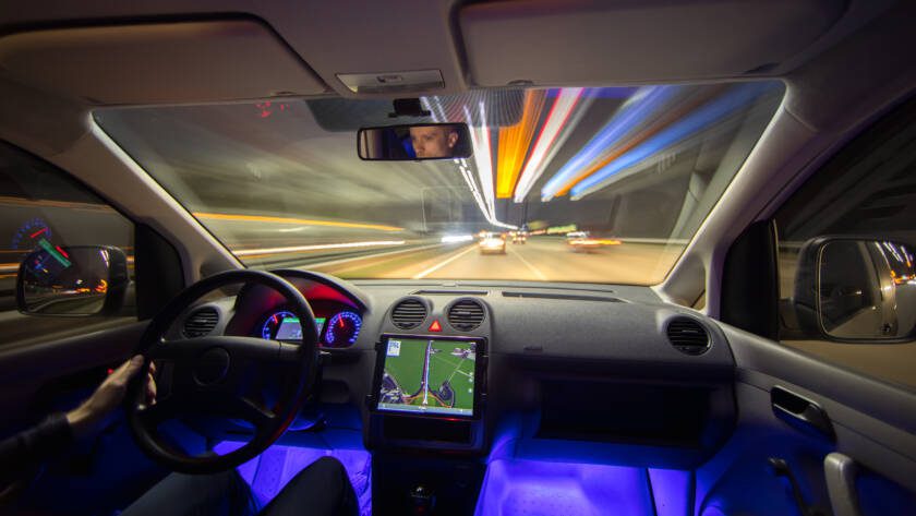 The man drive with navigation in the city highway. Evening night time