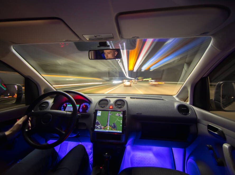 The man drive with navigation in the city highway. Evening night time